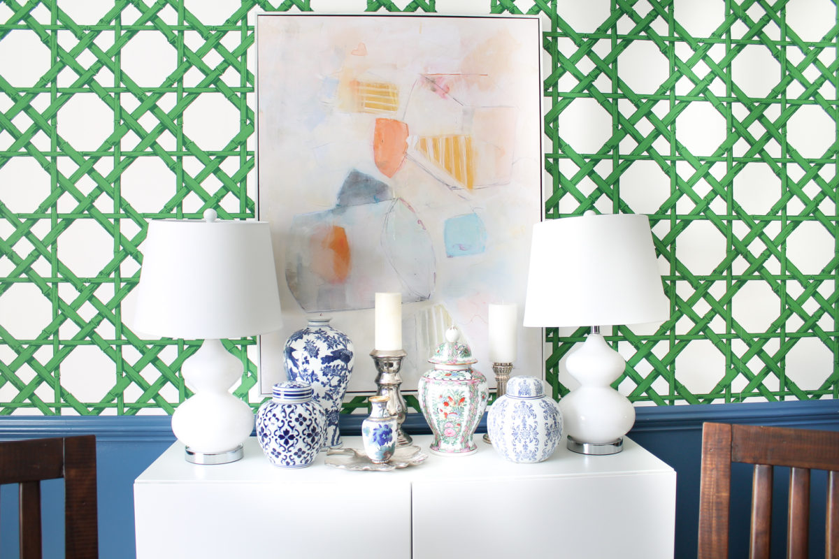 Blue and green dining room with blue and white ginger jars and cane wallpaper