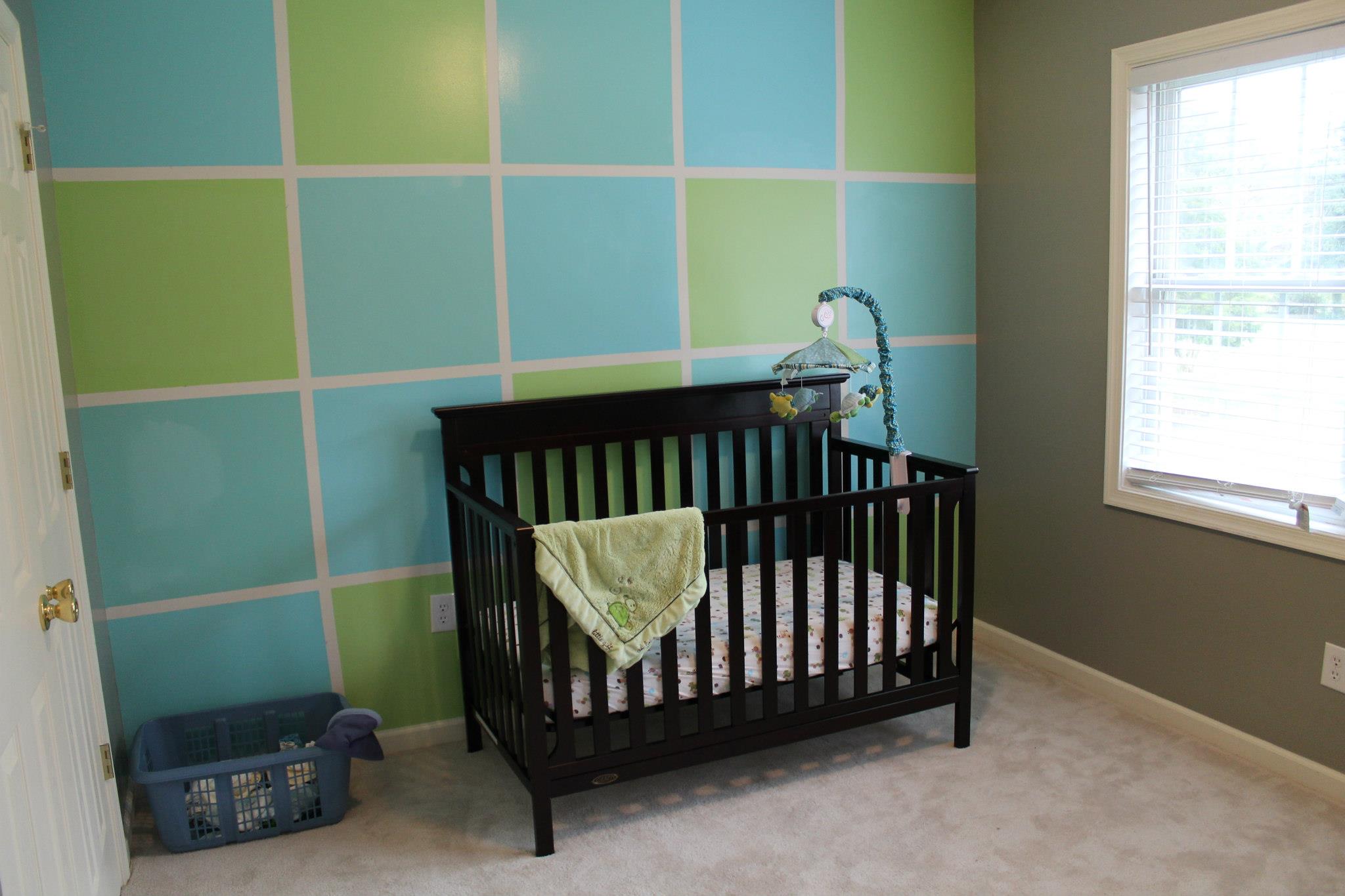 Green and Blue color block nursery with brown crib