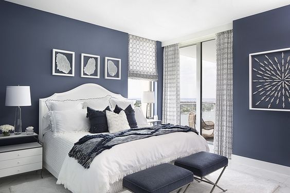 Sherwin Williams Indigo Batik is a darker, navy paint color great for bedrooms and cabinets, shown here in a bedroom 