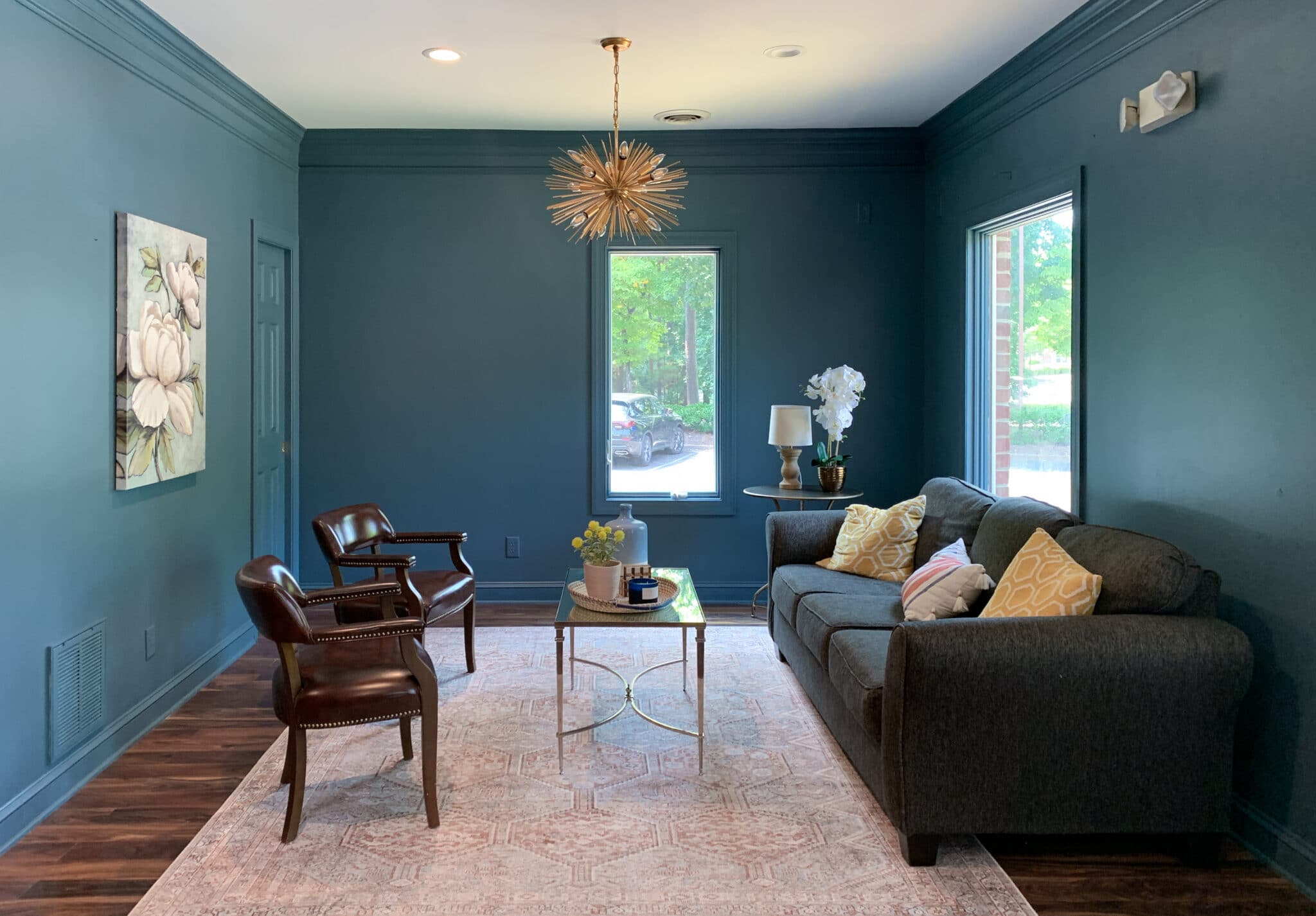 Lobby painted Sherwin Williams Waterloo with Chris Loves Julia Loloi rug and Sputnik chandelier