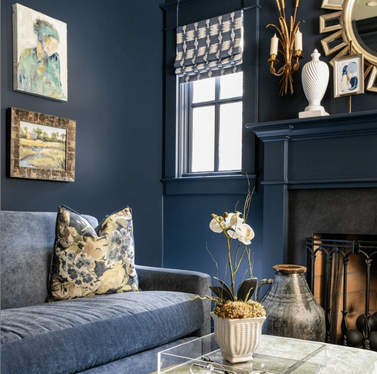 Sherwin Williams Blue Paint Colors showcasing Gale Force on the walls of this living room, including the trim, fireplace and a dark gray sofa to coordinate. 