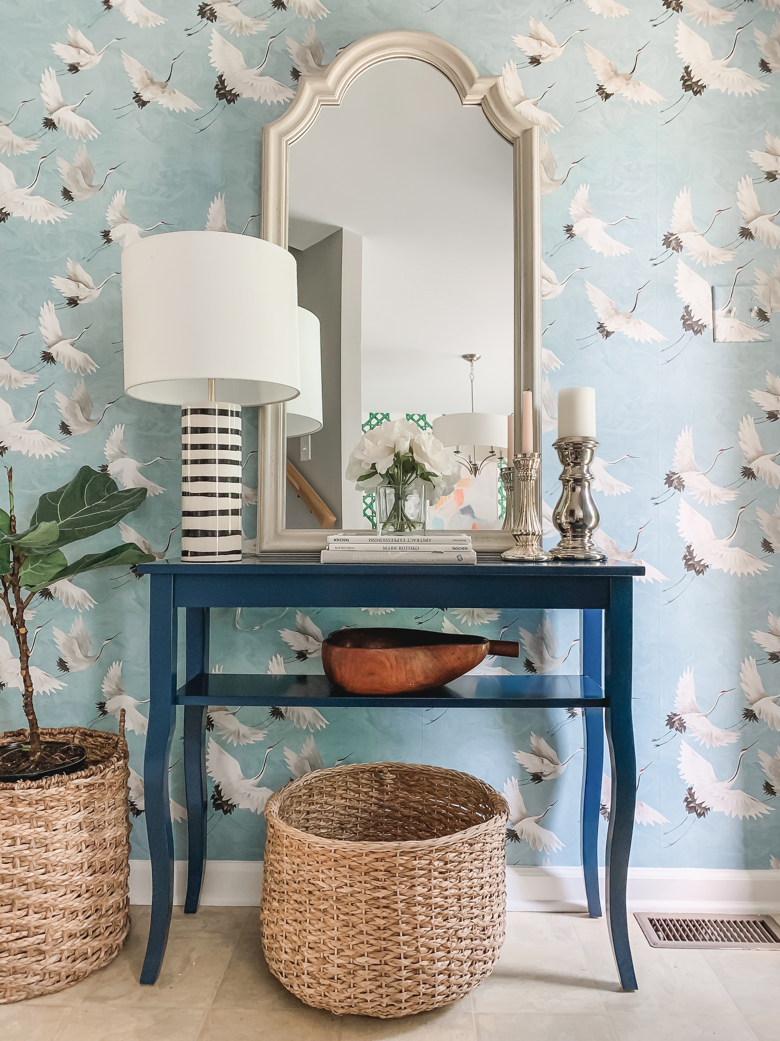 Bold, blue crane wallpapered entryway design with Sherwin Williams Stream painted door