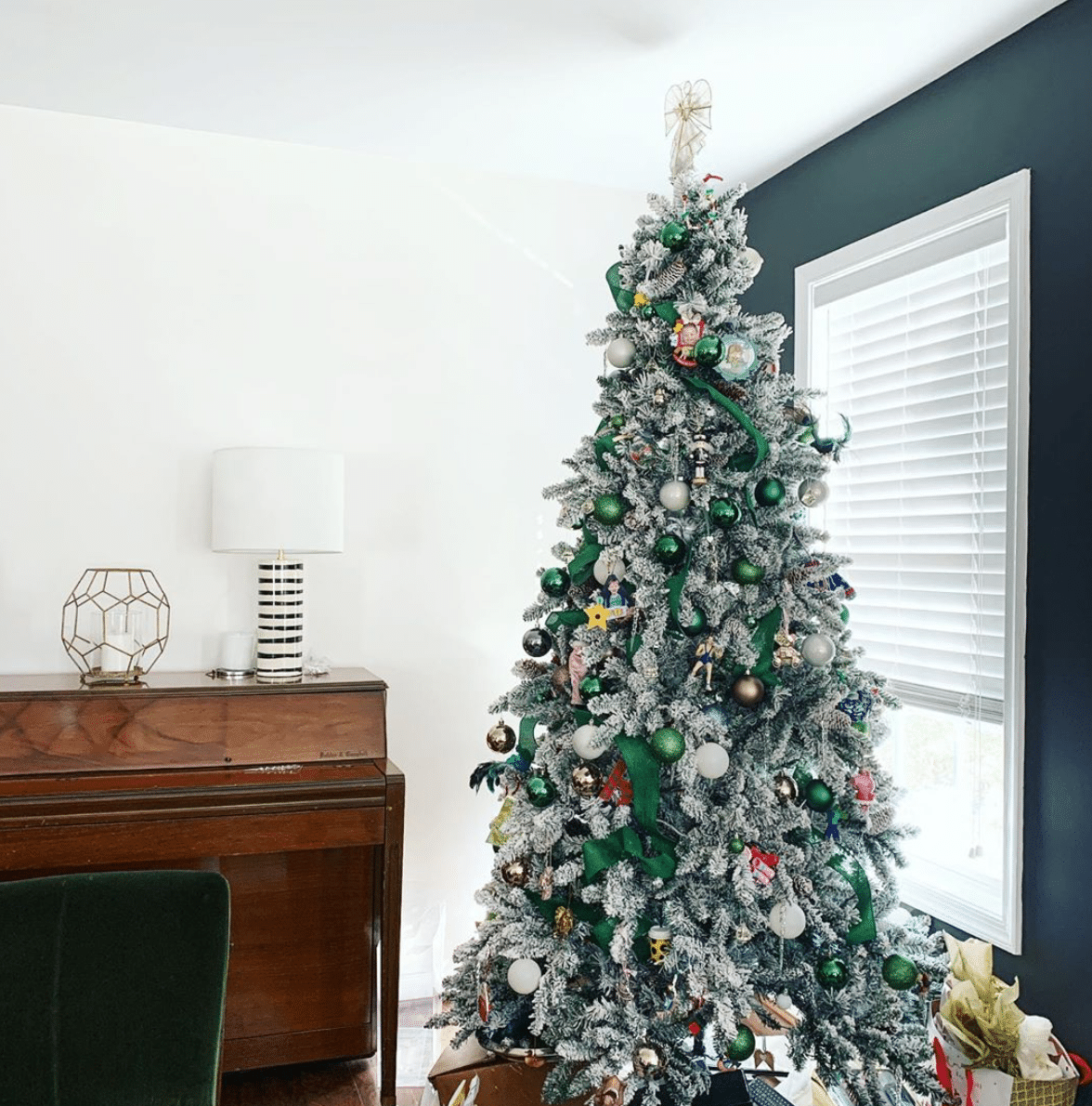 Green, White and Gold ornaments on a white flocked Christmas tree 