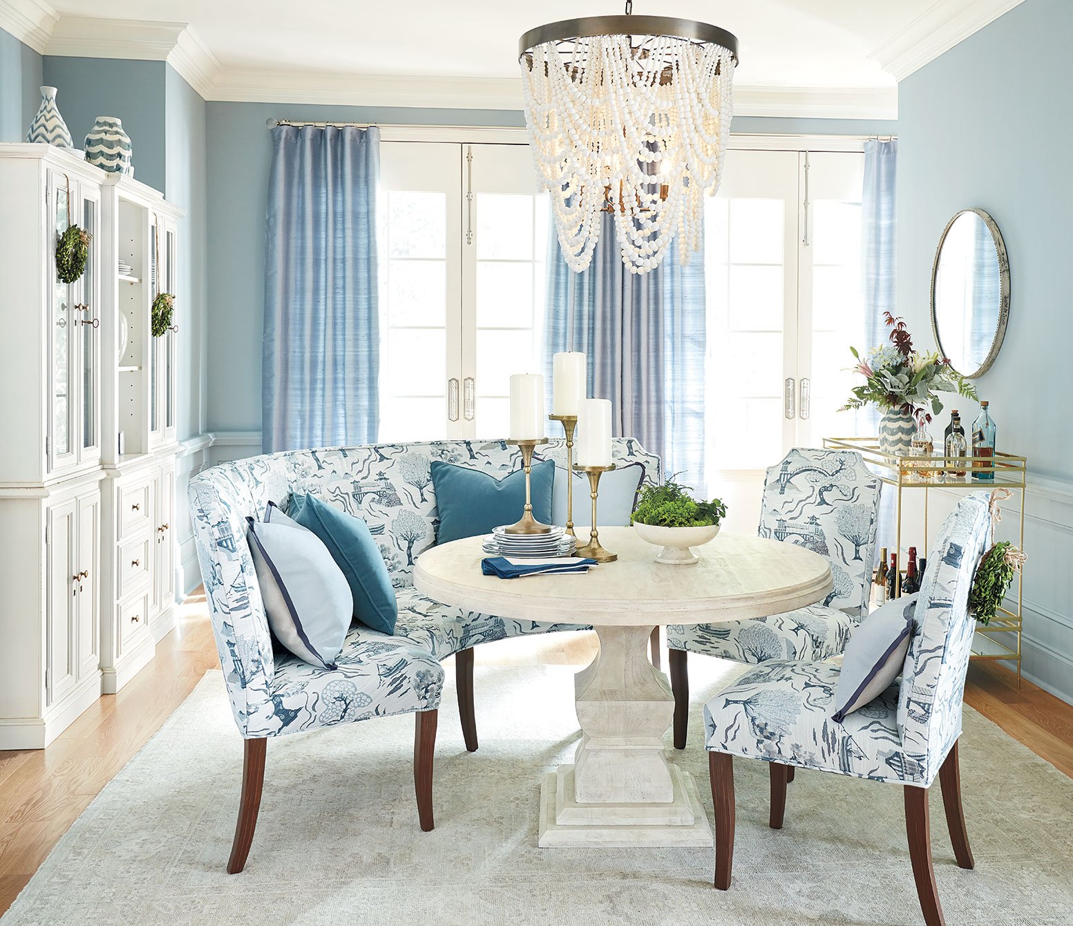 Cost to Furnish Your Entire Home in 2021. A dining room needs a rug, table, chairs, chandelier, artwork, curtains, sideboard and accessories.