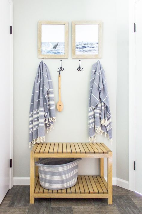 A bench and hooks provide a place for towels to dry and storage for bathroom essentials.