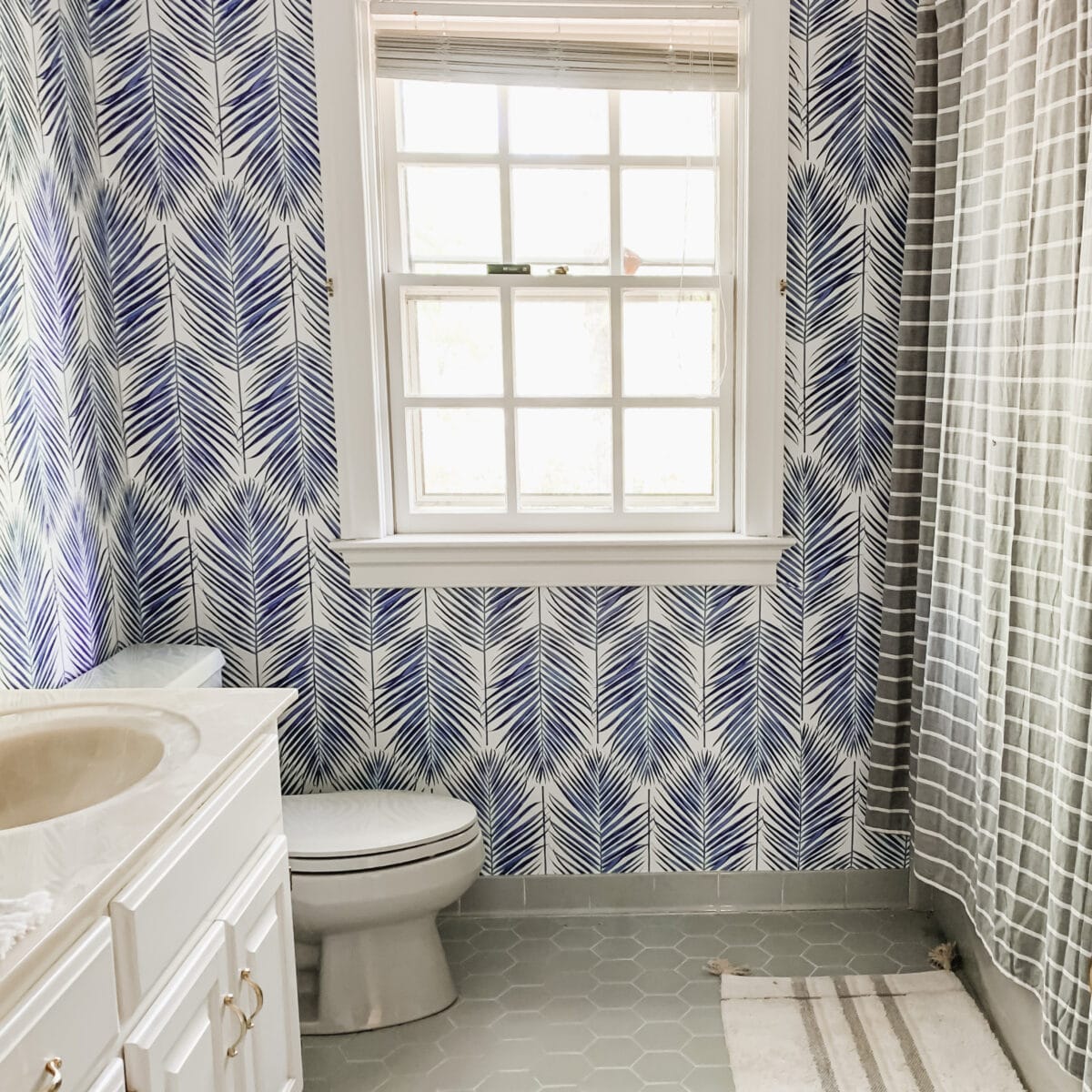 See the Kids Coastal Bathroom Update with Blue Palm Wallpaper