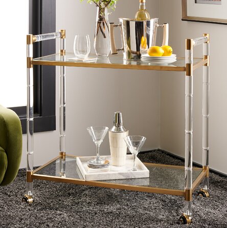 Gold and acrylic Bar Cart with glassware, drinks and gold accessories