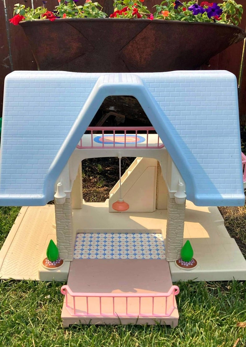 1990's Little Tikes plastic dollhouse with blue roof and pull out deck