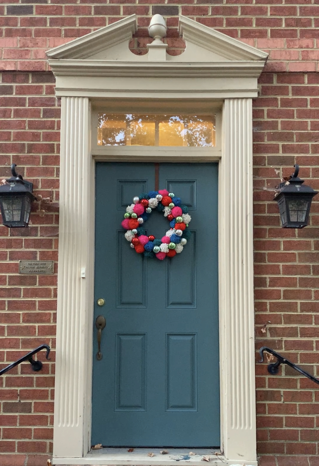 Font door of brick house painted in Sherwin Williams Riverway