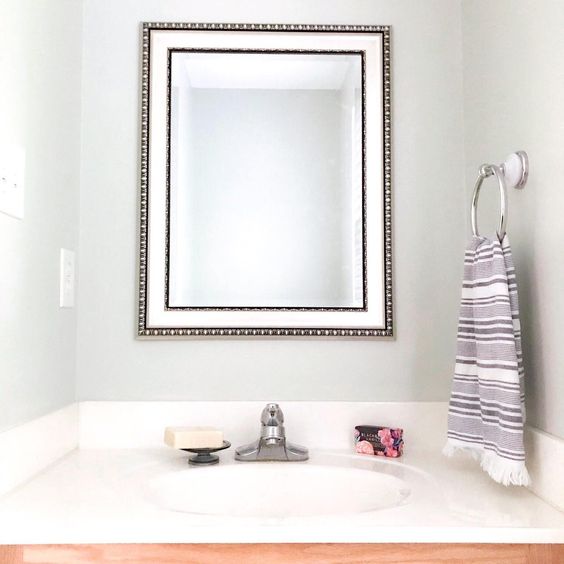 Sherwin Williams Sea Salt painted in a powder room with oak cabinets