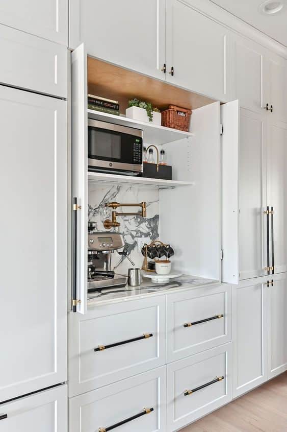 white cabinets with coffee station and marble backsplash